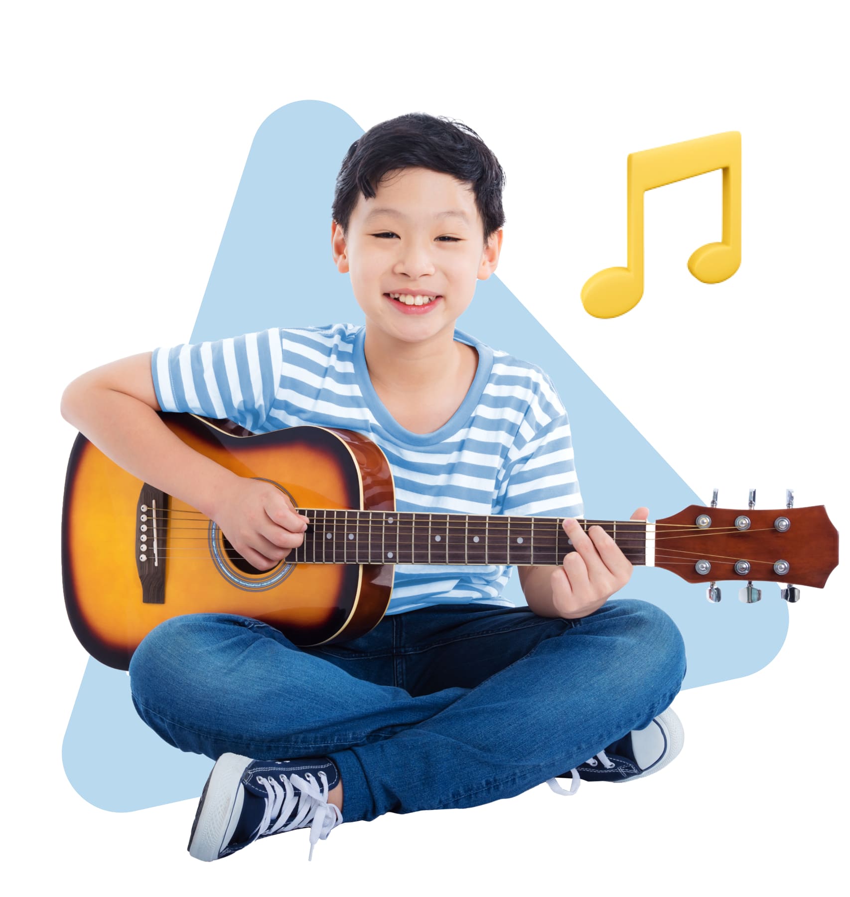 A young boy sits on the floor, strumming an acoustic guitar with a focused expression on his face.