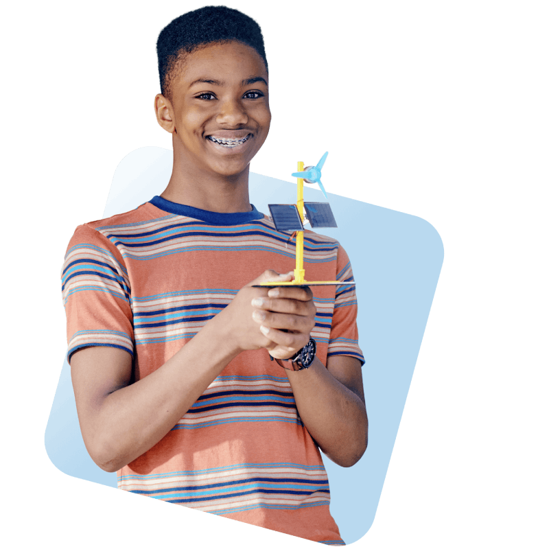 A young boy joyfully holds a colorful toy airplane, showcasing his excitement and imagination.