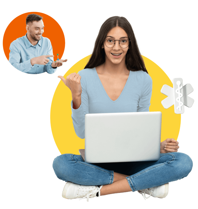 A woman sits on the floor with a laptop, while a man sits beside her, both engaged in a focused discussion.
