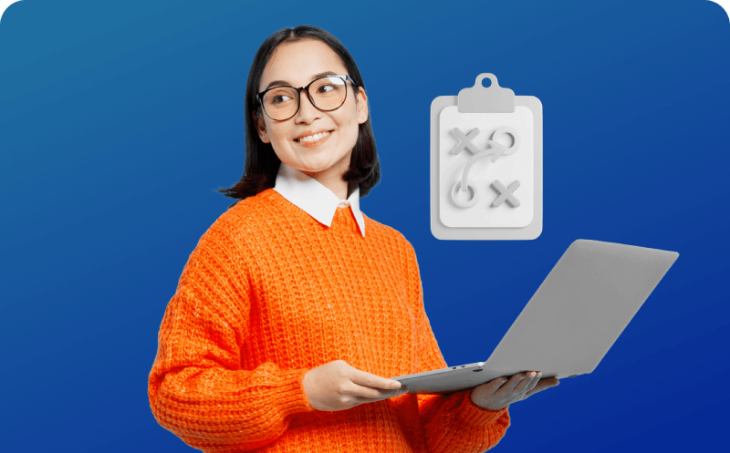 A woman stands confidently, holding a laptop adorned with a colorful sticker, showcasing her personal style and creativity.